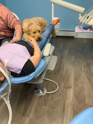 Copper offering comfort to a child during a dental visit