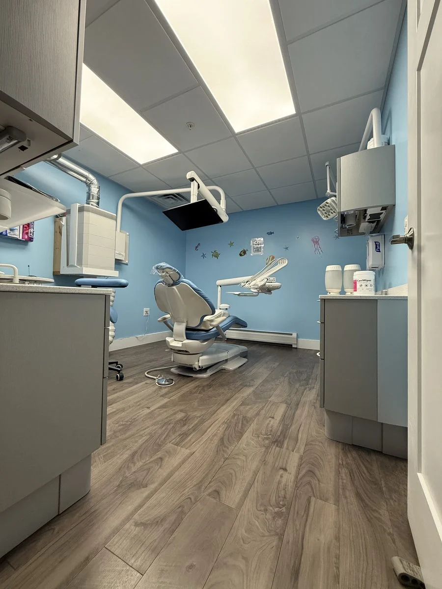 A treatment room with ocean-themed wall art