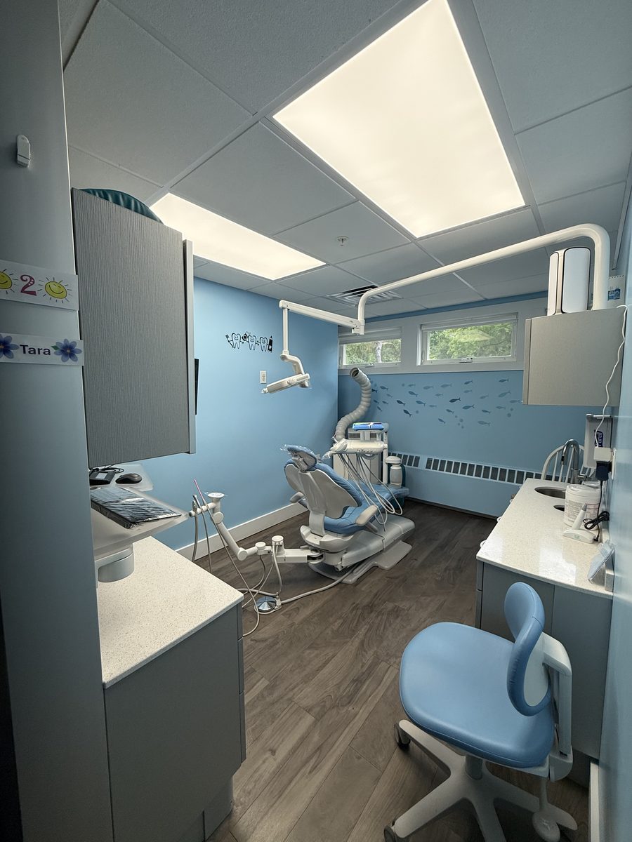 A child-friendly treatment room with a fish mural
